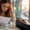 U.S. traveler reviewing documents about pre-existing conditions travel insurance US at airport before international trip